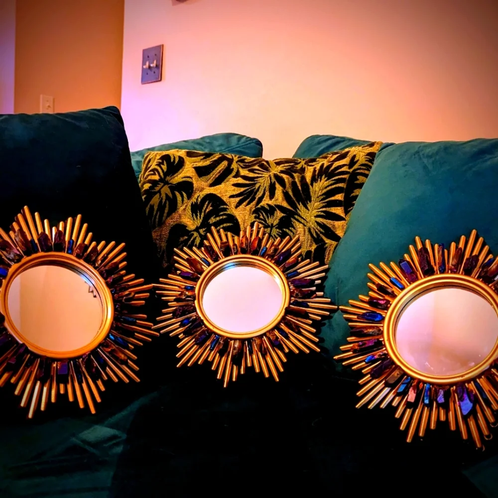 Set of three gold tone wall hanging accent mirrors with titanium coated quartz